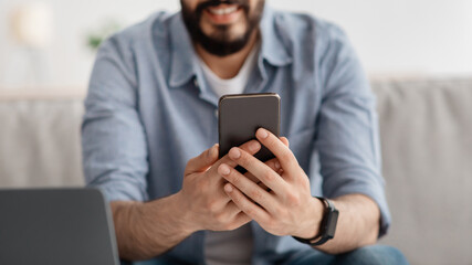 Modern technologies. Unrecognizable man browsing smartphone, reading message or surfing net