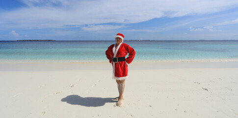 female santa claus on the coast of a tropical island