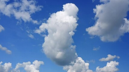 Wall Mural - Stunning view of a blue sky with some fluffy clouds. Aerial shoot, sliding movement. Natural background with copy space.