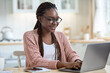 © Prostock-studio - Remote Business. Happy African American Freelancer Lady Working With Laptop In Kitchen