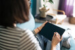 © maxbelchenko - Young woman using tablet, spending leisure time chatting in social network, freelancer working online. Working from home in quarantine lockdown. Education online.