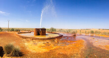 Orange Mineral Pool Of Natural Water Spring In Damia With Stream Or Rising Spring To The Air