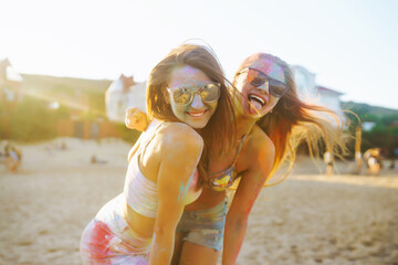 A group of friends have fun,  dance at the holi festival. Spring Break Beach Party. Celebrating traditional indian spring holiday. Friendship, Leisure, Vacation, Togetherness.