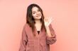 © luismolinero - Young caucasian woman isolated on pink background showing ok sign with fingers