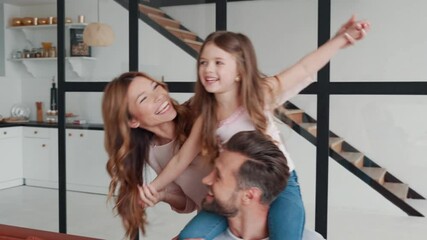 Wall Mural - Happy young family smiling and embracing while bonding together at home