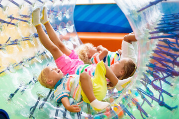 Wall Mural - Child play in roller wheel. Kids on trampoline.