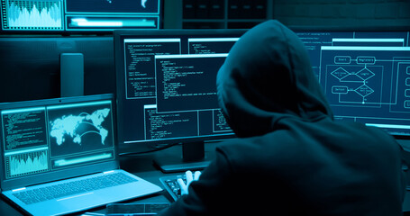 asian male hacker use laptop