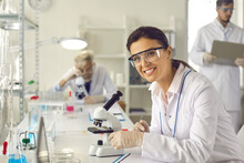 Building Successful Career In Science Research. Smart Beautiful Woman Working In Laboratory, Using Lab Equipment, Doing Experiment, Studying Test Samples. Portrait Of Happy Scientist Looking At Camera