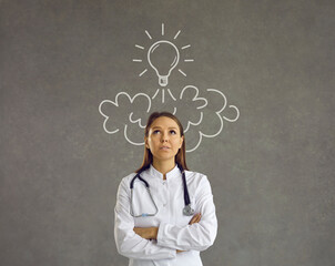 Wall Mural - Nurse in lab coat and stethoscope looking up at line doodle light bulb shaped rocket flying above head. Smart doctor thinking of launching business startup developing bright innovative healthcare idea