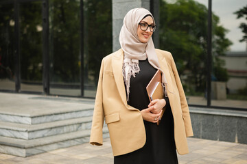 Wall Mural - modern stylish muslim woman in hijab in city street