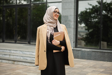 Wall Mural - modern stylish muslim woman in hijab in city street