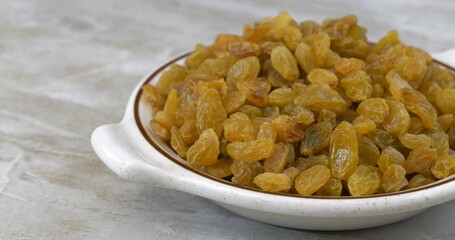 Sticker - Bowl of golden raisins sliding into view on a kitchen counter