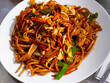 © JackF - Indonesian style spicy fried noodle dish with sliced onion, pepper, carrot, meat and egg..