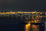 Fototapeta  - View of the embankment of the city of St. Petersburg at night with drawbridges