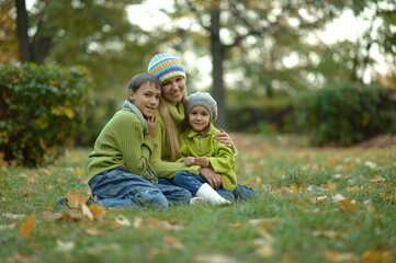 Happy smiling family relaxing in autumn park