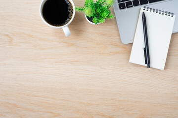 Wall Mural - Top view above of Wood office desk table with keyboard of laptop notebook and coffee cup with equipment other office supplies. Business and finance concept. Workplace, Flat lay with blank copy space.