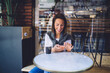 © BullRun - Positive lady with cellphone and coffee in cafe