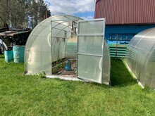 Greenhouse In The Garden. Growing Vegetables And Fruits In A Greenhouse.