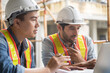 © saksit - Engineering team working at building site meeting and discussing on laptop . Team onsite of architecture inspector and discuss together