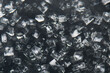 Table salt Isometric, cubic transparent crystal growth from a supersaturated NaCl solution in water.  Examples of crystalline structure. Dark background. View from above.