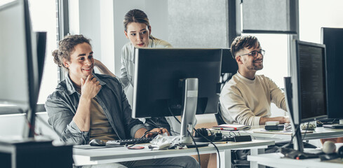 Group of designers programmers working on a new project at the office.	
