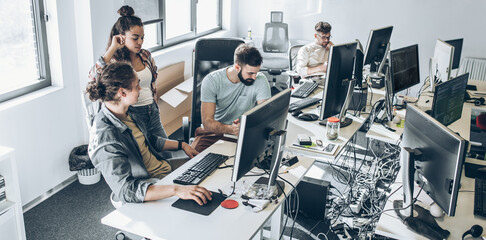 Group of designers programmers working on a new project at the office.	
