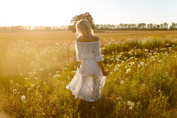 Beautiful blond women in the natural fields in the light of sunshine. Best for illustration of beauty and freedom