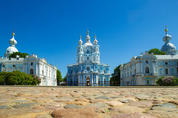 Wall Mural - Sights of Saint-Petersburg. Smolny Cathedral on the background of paving stones. Smolny Cathedral on a summer day. Cities of Russia. Cathedrals of St. Petersburg. Petersburg in the summer.