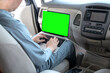 © photobuay - Mechanic using laptop computer to check during work a car engine on car at repair garage. focus finger hand. Green screen