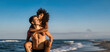 © Lomb - Multicultural couple of happy young lovers piggybacking on the beach