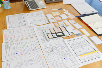 Graphic designers work together with UX UI designer planning application template layout framework for mobile phone computer mobile
