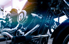 Selective Focus On A Motorcycle Engine. Closeup Motorcycle Exhaust Pipe, Engine Guard, Air Filter, And Rear Brake Pedal. Motorcycle Industry. Shiny Chrome Motorbike Engine. Vintage Motorbike.