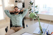 © New Africa - Businessman relaxing in office chair at workplace