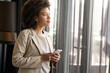 © NDABCREATIVITY - Casual beautiful black businesswoman using phone in her office