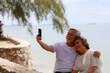 © sutthichai - Happy Asian senior couple enjoy playing smartphone outdoor. Retirement and love concept.