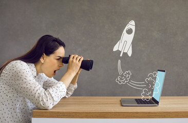 Side profile view astonished lady looking in binoculars at rocket flying out laptop computer screen. Surprised girl watching accelerated growth of modern digital startup of successful business rival