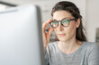 © StockPhotoPro - Woman with glasses working with a computer