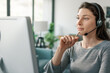 © StockPhotoPro - Woman wearing a headset and working with her computer