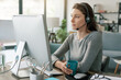 © StockPhotoPro - Woman wearing a headset and working with her computer