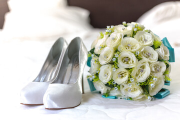 Sticker - Closeup shot of high heels and wedding bouquet on the bed