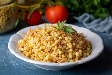 Wall Mural - Traditional delicious Turkish food; Couscous pilaf with vermicelli (Turkish name; Sehriyeli kuskus pilavi)