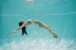 © LIGHTFIELD STUDIOS - peaceful young woman in white swimsuit swimming in pool