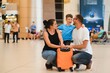 © Serhii - Portrait of traveling family with suitcases in airport