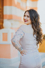 Poster - Vertical shot of a beautiful young Caucasian female posing outdoors in a formal gown