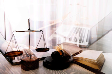 Business and lawyers discussing contract papers with brass scale on desk in office. Law, legal services, advice, justice and law concept picture with film grain effect