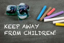 Keep Away From Children. Laundry Capsules With Gel For Washing. Gray Chalk Board Background