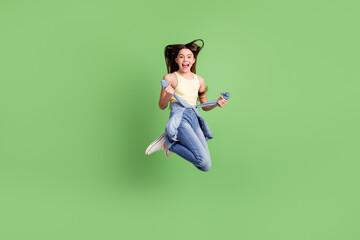 Poster - Full size portrait of excited carefree pupil open mouth arms hold touch tie front isolated on green color background