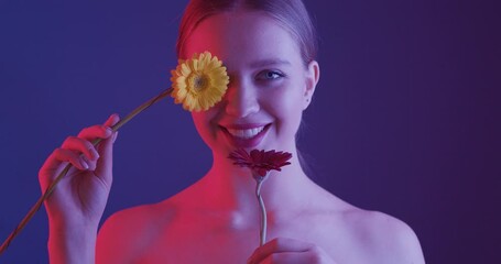 Canvas Print - Beautiful young woman with gerbera flowers on color background