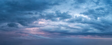 Dramatic Overcast Sky At Evening Panoramic Shot. Scenic Blue Gray Clouds Before The Storm. Scenic Cloudscape Before The Rain. Blue Hour Stormy Cloudscape. Dark Thunderstorm Sky Wide Image.