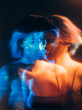 © golubovy - Split mind. Bipolar disorder. Dual personality. Defocused double exposure disturbed anxious woman art silhouette in blue orange neon light on dark.